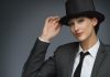 Young,Business,Woman,Wearing,Top,Hat,Over,Grey,Background.,Woman