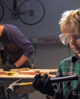 Boy,In,Glasses,Stands,And,Looks,At,The,Hammer