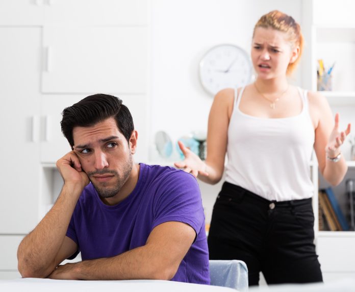 Frustrated guy at table with dissatisfied girlfriend