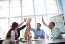 Photo,Editors,Giving,High-five,In,Meeting,Room,At,Creative,Office