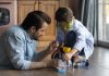 Caring millennial father and preteen son doing funny chemical experiments